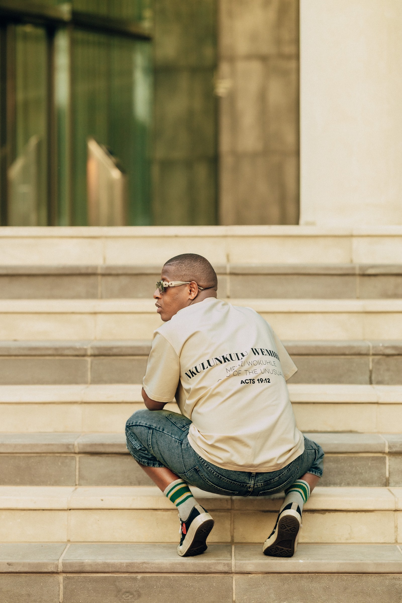 A model in an Unusual shirt outside a building