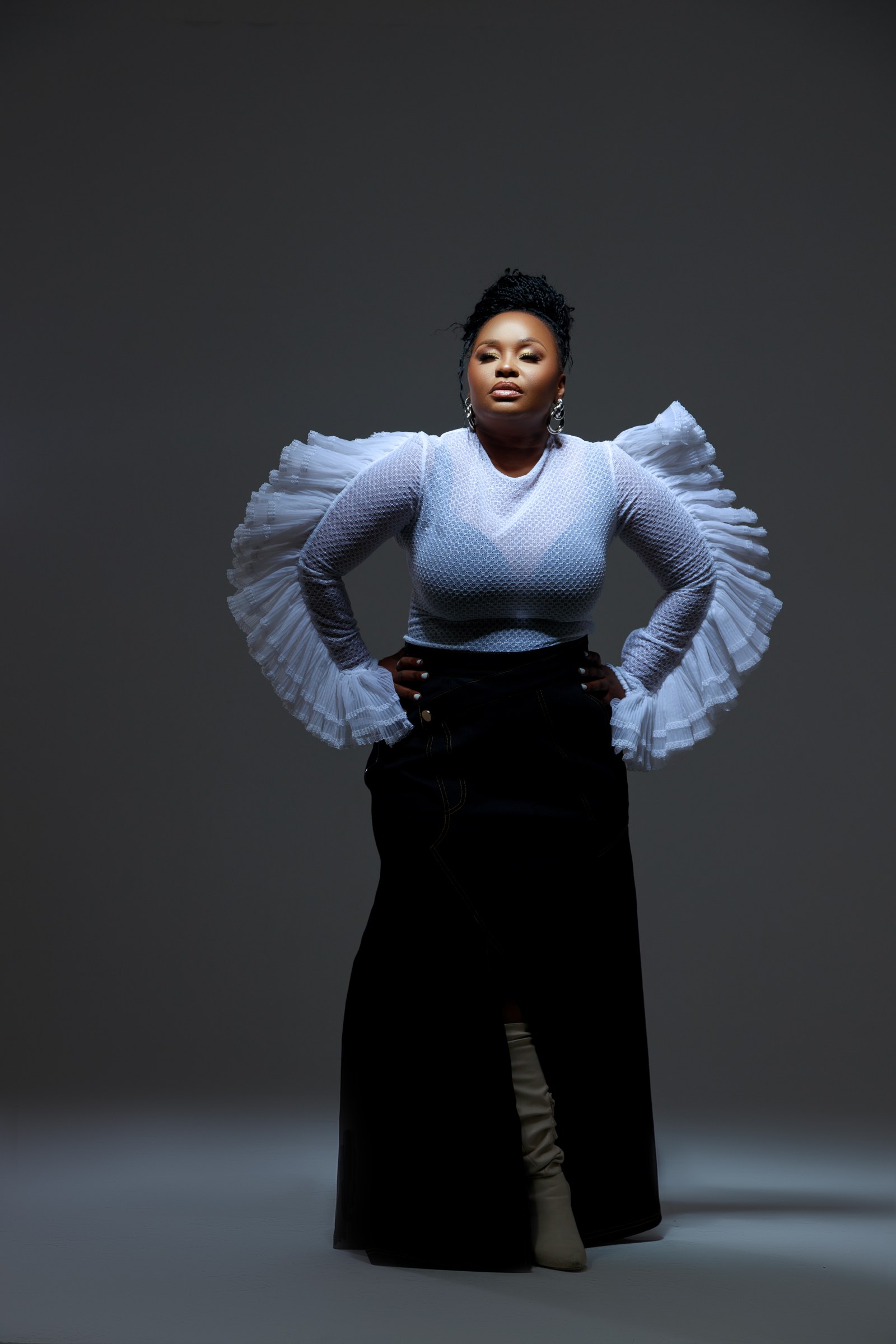Xolly in a white architectural blouse and dark trousers