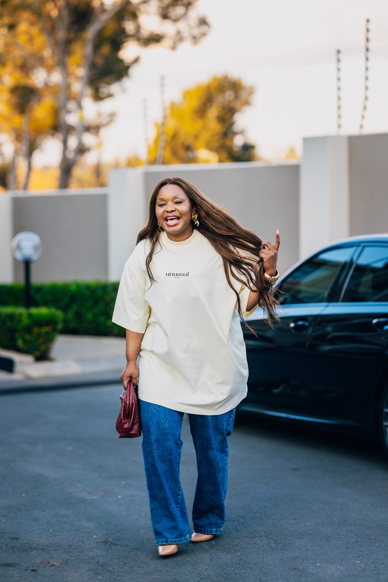 Xolly in an Unusual T-shirt beside a car