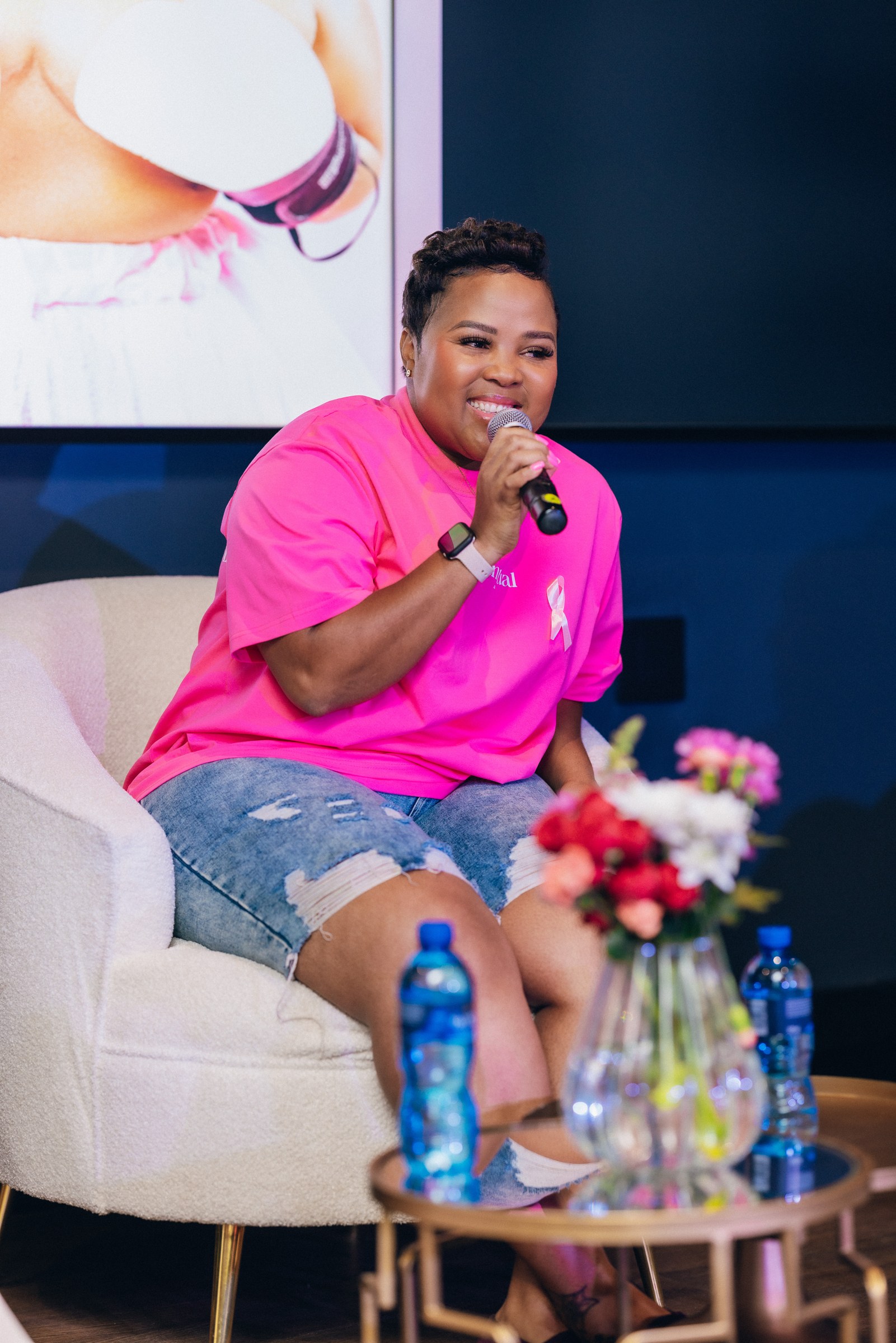Xolly speaking into a microphone at a community event