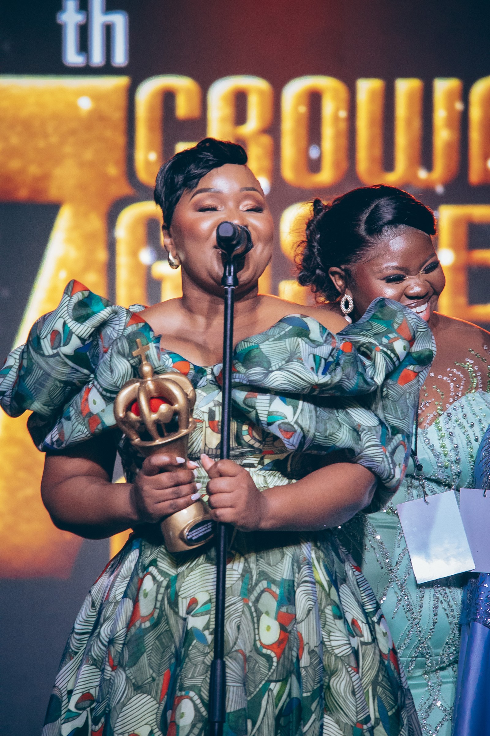 Xolly holding an award with another guest