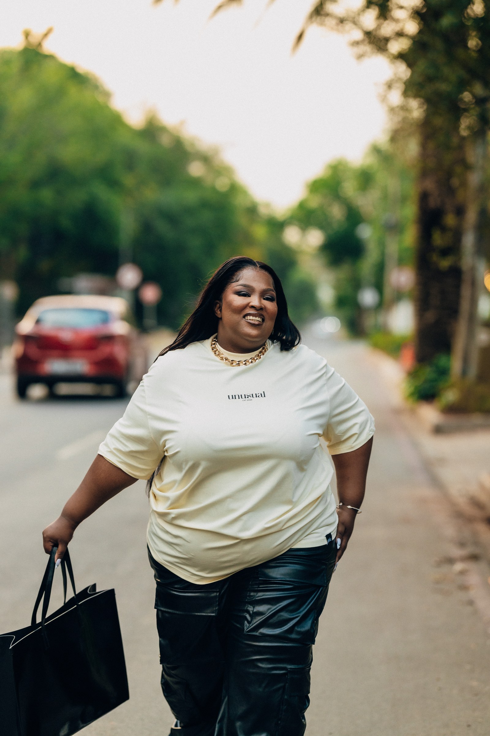 A model in an Unusual T-shirt on a tree-lined street